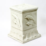 Dolphin sculpture with two dolphins leaping above ornate pedestal featuring classical reliefs in old world European style. Different Angle