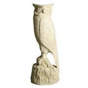 Owl statue with detailed feathers and classical old world European style, perched on a textured base with ornate carving.