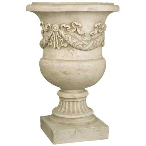 Ornate classical urn planter with fluted pedestal base and Baroque-inspired garland detailing in old world European style.