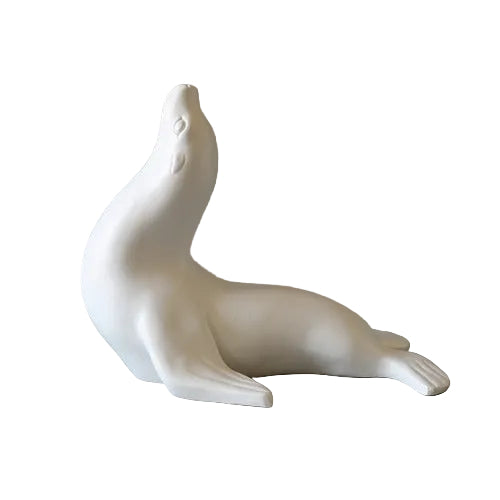 Seal figurine with smooth, minimalist lines and subtle classical detailing, evoking a serene, old world European aesthetic. Side View