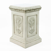 Classical European statue of a robed woman on an ornate pedestal with Renaissance and Baroque decorative reliefs. Different Angle