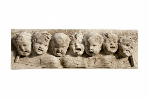Baroque-style sculpted relief of seven cherubic faces with expressive features in an ornate, old world European design. Side View