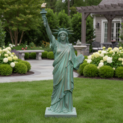 Statue of Liberty replica with classical draped robe, ornate crown, and raised torch in neoclassical architectural style. Side Angle