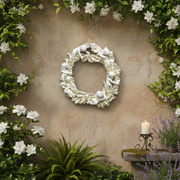 Ornate Baroque-style wreath adorned with classical cherubs and intricate leaf detailing in an old world European design. Side Angle