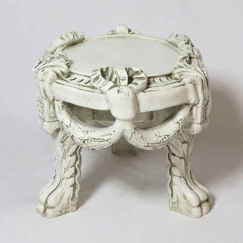 Ornate classical stool with carved Baroque details, draped garland motifs, and sculpted cabriole legs in old world European style.