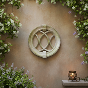 Ornate round window grille with intersecting arches, old world European style, featuring classical and medieval architectural details. Side Angle