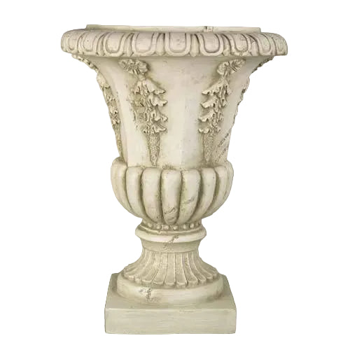 Ornate classical urn planter with fluted base and Baroque floral relief, inspired by old world European architectural design.