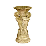 Baroque pedestal planter with ornate cherub figures supporting a fluted bowl, featuring classical old world European detailing.