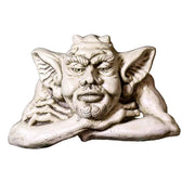 Grotesque gargoyle head with pointed ears and ornate facial features in a medieval Gothic style, resting on crossed arms. Side View