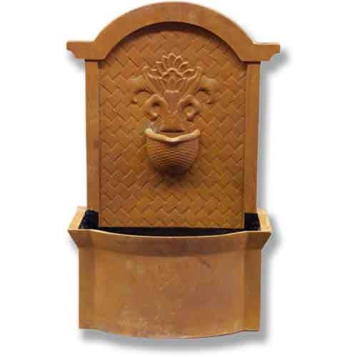 Wall fountain with ornate old world European design, arched top, classical floral motif, and woven basket detail.