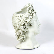 Classical Greek-style bust with ornate, wavy hair and serene expression, inspired by Renaissance and old world European sculpture. Side Angle View