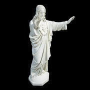 Jesus statue with outstretched arms, classical Renaissance style, ornate detailing, flowing robes, sacred heart motif on chest. Side Angle View