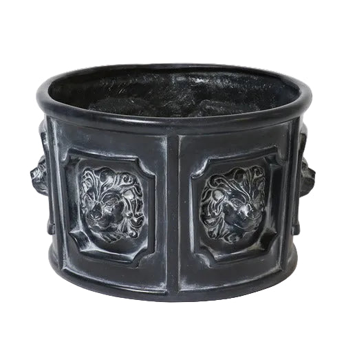 Ornate round planter with classical lion head reliefs in an old world European Baroque style, featuring detailed sculptural panels. Side View