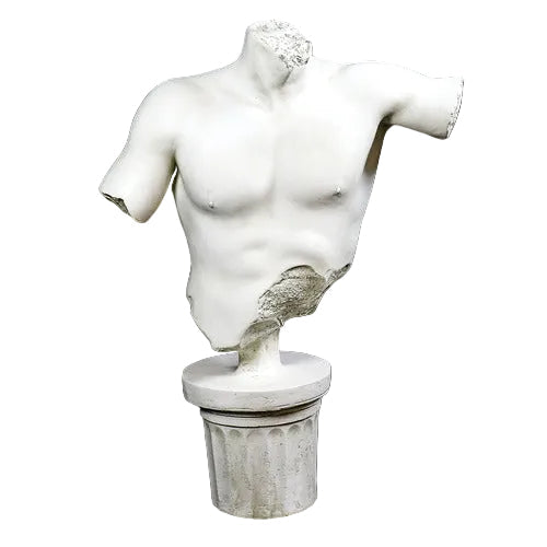Classical Greek male torso sculpture with missing head and arms, displayed on an ornate fluted pedestal in old world European style. Side View