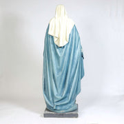 Virgin Mary statue in classical old world European style, standing with open arms on a pedestal adorned with stars and a serpent. Other Angle