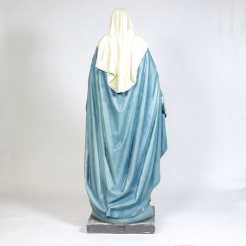 Virgin Mary statue in classical old world European style, standing with open arms on a pedestal adorned with stars and a serpent. Other Angle
