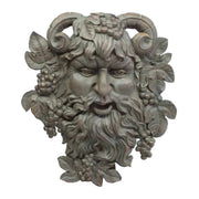 Grotesque bearded face with ram horns, grape clusters, and ornate leaves in an old world European classical style. Side View