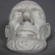 Classical old world European sculpted head with closed eyes, detailed facial features, and a prominent beard in Renaissance style. Other Angle
