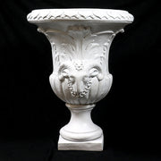 Ornate classical urn with Baroque detailing, acanthus leaf motifs, and ram head accents on a pedestal base. Other Angle