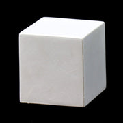 White geometric cube with smooth, clean edges and minimalist, classical design set against a solid black background. Side Angle