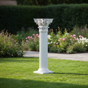 Corinthian column pedestal with fluted shaft and ornate acanthus leaf capital in classical old world European style. Side Angle