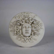 Medusa head relief with intricate serpentine hair, classical Greek style, ornate detailing, and dramatic facial expression. Side Angle