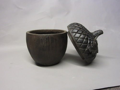 Acorn-shaped container with ornate, old world European style lid featuring detailed leaf and textured pattern Side Angle