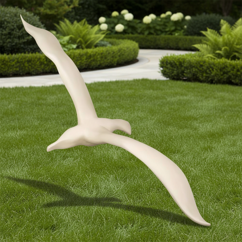 Sculpted seagull wall decor with elongated wings and smooth, minimalist lines in a classical European style. Side Angle