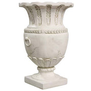 Ornate classical urn with fluted rim, laurel leaf detailing, and ring handles in an old world European style. Side View
