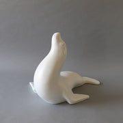 Seal figurine with smooth, minimalist lines and subtle classical detailing, evoking a serene, old world European aesthetic. Different Angle
