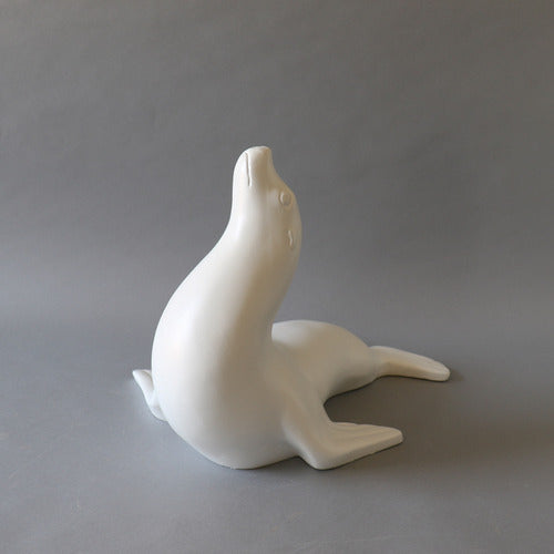 Seal figurine with smooth, minimalist lines and subtle classical detailing, evoking a serene, old world European aesthetic. Different Angle