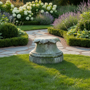 Ornate classical pedestal base with weathered, old world European detailing and leaf motif, evoking a Renaissance architectural style. Side Angle