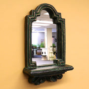 Arched mirror with ornate old world European frame and classical detailing, featuring a decorative Baroque-inspired shelf base. Side Angle