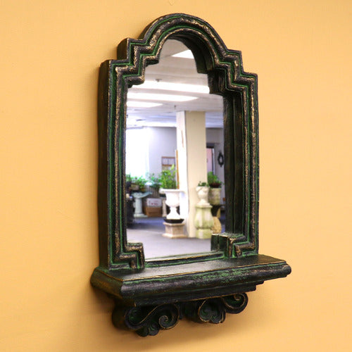 Arched mirror with ornate old world European frame and classical detailing, featuring a decorative Baroque-inspired shelf base. Side Angle