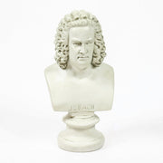 Classical European bust with ornate, curly hair in old world style, displayed on a pedestal with Renaissance-inspired detailing. Different Angle