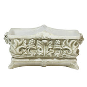 Ornate rectangular planter with classical Baroque relief patterns and intricate scrollwork, featuring lush green foliage. Side Angle
