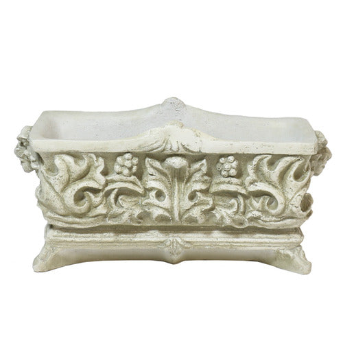 Ornate rectangular planter with classical Baroque relief patterns and intricate scrollwork, featuring lush green foliage. Side Angle