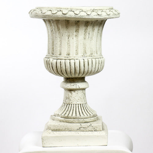 Ornate classical urn planter with fluted detailing atop a Greek-inspired Ionic column pedestal, featuring old world European style. Side Angle