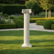 Classical Greek column pedestal with ornate Ionic scrolls and fluted shaft, featuring an old world European architectural style. Side Angle