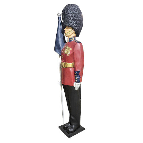 British royal guard statue in ornate old world European style uniform, tall bearskin hat, holding a flag, classical military theme Other Angle