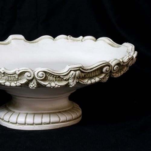 Ornate pedestal bowl with scalloped edge and classical Baroque detailing, featuring intricate scrollwork and old world European design. Side Angle