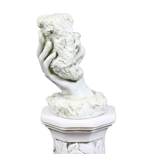 Classical sculpted hand emerging from ornate pedestal, holding a textured stone in old world European style Side Angle