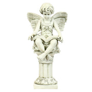 Cherub statue with butterfly wings seated on a classical pedestal, reading a book, featuring ornate old world European details. Side View