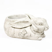 Rabbit-shaped planter with ornate floral motif, featuring old world European style and filled with yellow and orange flowers. Additional Angle