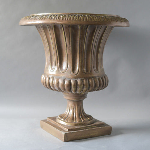 Classical urn with fluted body, ornate rim, and pedestal base in old world European style. Side Angle
