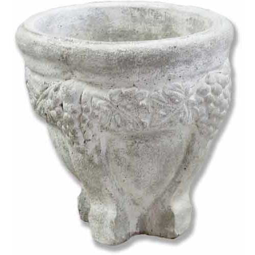 Ornate old world European planter with classical grapevine relief and sculpted pedestal base, evoking Renaissance garden style.