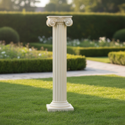 Classical Greek column pedestal with ornate Ionic capital and fluted shaft, featuring an old world European architectural style. Side Angle