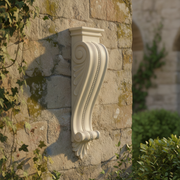 Ornate classical corbel with scrollwork, beaded detailing, and acanthus leaf motif in old world European architectural style. Side Angle