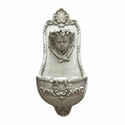 Wall fountain with ornate Baroque detailing, classical cherub face, and intricate scrollwork in old world European style. Side View