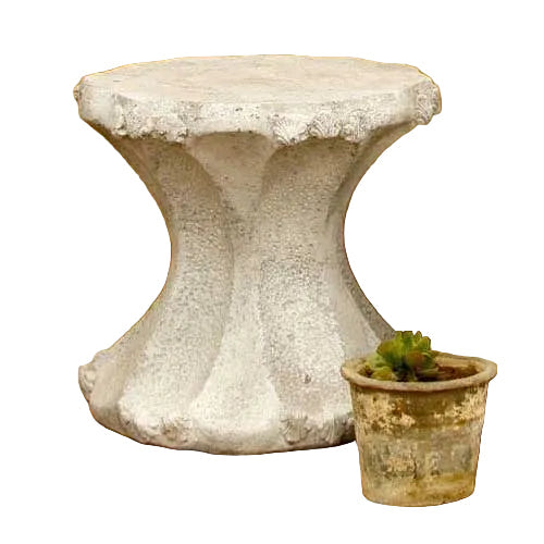 Ornate old world European pedestal table with scalloped edges and fluted base, paired with a small classical planter.